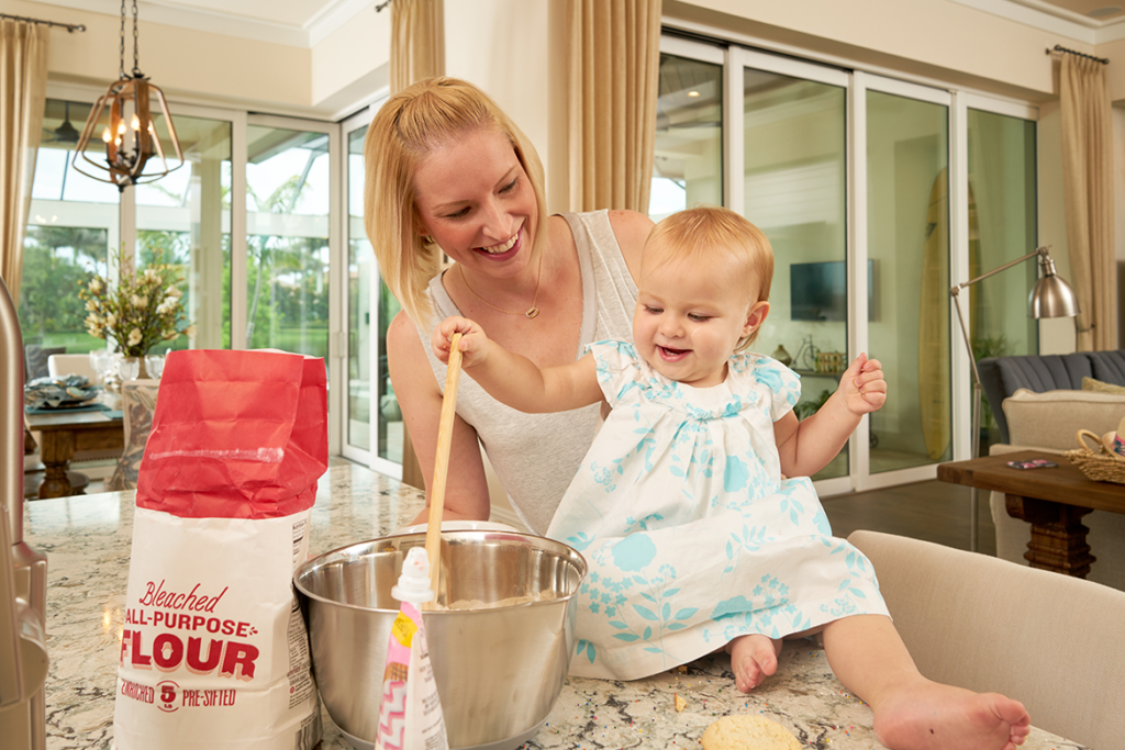 Mother and daughter baking together in quiet house